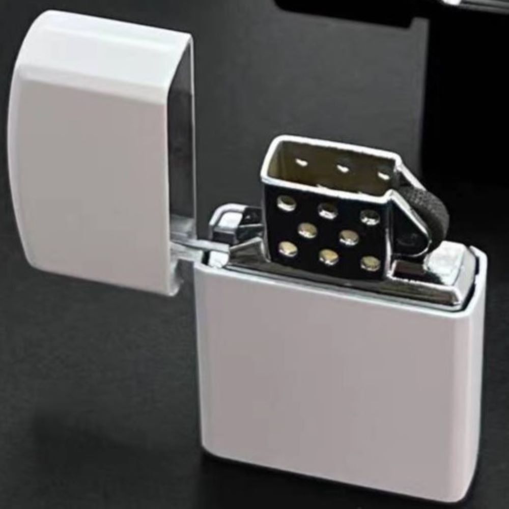 Metallic lighter with open lid on a dark background Soft Flame Lighter